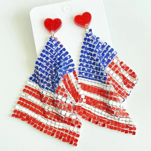 Close-up of glitter heart stud and American flag mesh fabric on dangling earrings