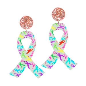 Detail of acrylic awareness ribbon earrings with glitter studs and colorful pattern