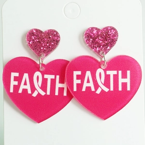 Close-up of pink acrylic heart earrings featuring Faith text and breast cancer ribbon