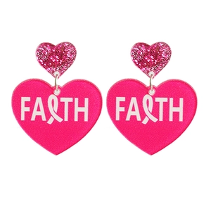 Detailed macro view of heart acrylic earrings with FAITH text and pink ribbon symbol