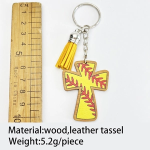 Detail view of wooden softball cross keychain with leather tassel and measuring ruler