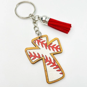 Detail of wooden baseball cross keychain with red stitching, red tassel, and metal ring