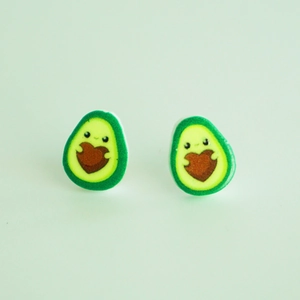 Cute cartoon avocado stud earrings with heart shaped pits on a light blue background