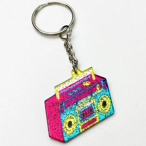 Close-up of retro boombox keychain with colorful glitter and vibrant gradient colors