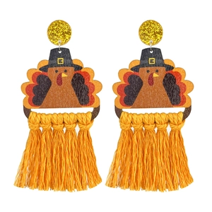 Handmade Thanksgiving earrings with turkey charm and bright orange tassels for holiday