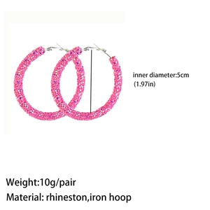 Macro detail of large pink rhinestone hoop earrings showing 5cm diameter and texture