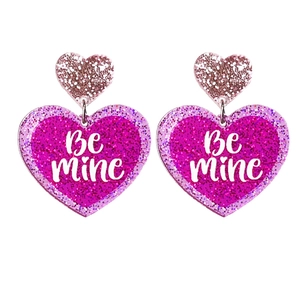 Sparkly pink acrylic heart earrings with Be Mine text for Valentine's Day party