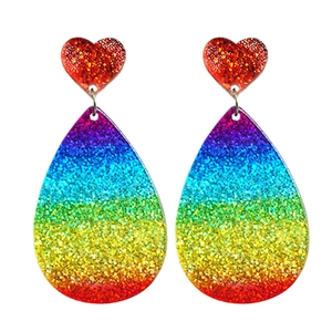 Detail of glittery rainbow heart and teardrop dangle earrings with vibrant sequins
