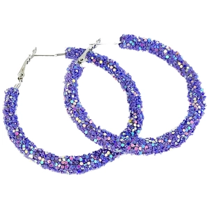 Macro shot of large purple glitter hoop earrings with sparkling sequins for party wear
