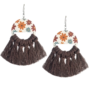 Detail of bohemian wooden floral earrings with brown woven fringe and vintage patterns
