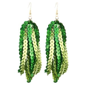 Detail shot of green sequin tassel earrings with layered round discs and gold metal hooks