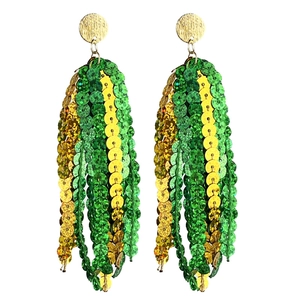 Close-up of green and yellow sequin tassels hanging from textured gold stud earrings