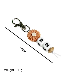 RN beaded nurse keychain with orange daisy silicone bead and wood charm, 10cm length