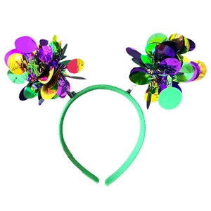 Detail of vibrant green fabric headband with large purple, gold, and green sequin pom-poms
