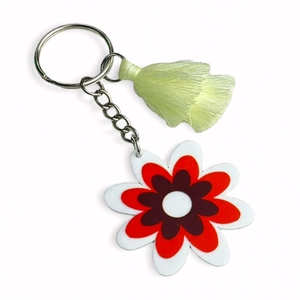Detail of vintage flower keychain featuring colorful acrylic floral pendant and green tassel