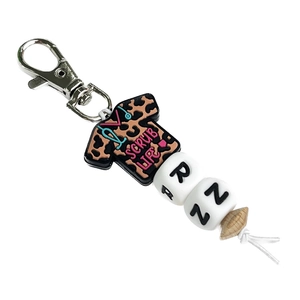 Nurse Scrub Life keychain with leopard print tee, RN letter beads and silicone charms