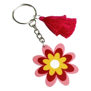 Colorful hippie flower keychain with pink tassel and silver ring on white background