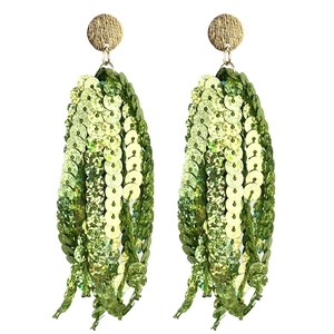 Detail of green sequin tassel earrings with gold metal discs for St. Patrick's Day party
