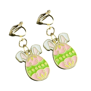 Detail of Easter egg clip-on earrings with colorful enamel patterns and bunny ears