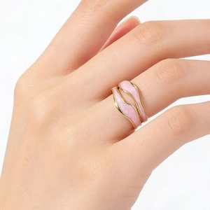 Golden double-layer wave ring with pink enamel detail on finger for women fashion