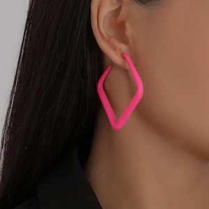 Model wearing bold fluorescent pink geometric hollow square drop earrings with matte finish