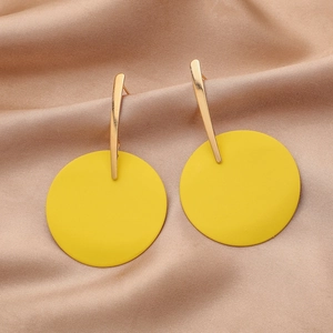 Detail of yellow matte drop earrings on champagne satin showing metal texture