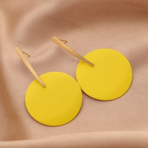 Modern geometric earrings featuring bright yellow round discs and gold-tone metal studs