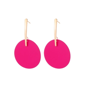 Detail view of bold magenta drop earrings with rose gold hooks and matte finish
