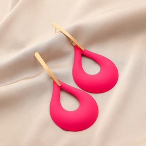 Detail of matte rose red hollow teardrop earrings with gold rectangular metal bars on silk