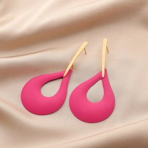 Detail of matte rose pink teardrop earrings with gold hardware on silk background