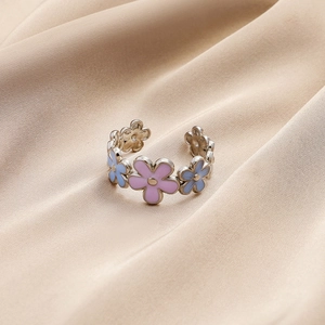 Sweet floral open ring with colorful enamel flowers on champagne satin background