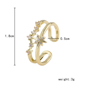Détail de bague dorée ajustable avec étoile, zircone et mesures de dimensions précises