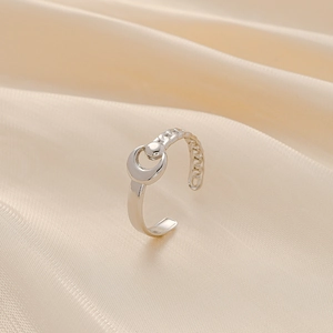 Detailed view of crescent moon hollow ring in silver finish on soft silk fabric