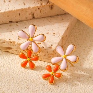 Pink and orange stacked flower earrings with gold plating on a natural stone base