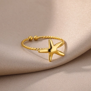 Elegant 18K gold plated starfish open ring with twisted rope texture on silk background