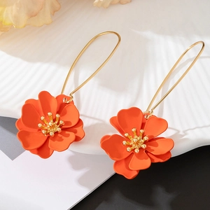 Vibrant orange matte petal flower drop earrings with golden hook on minimalist background