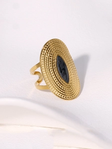 Detailed close-up of wide gold-plated stainless steel ring with vintage oval emblem
