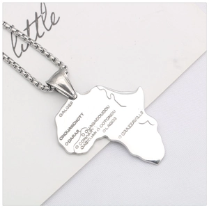 Macro shot of stainless steel Africa map pendant with engraved city names on box chain