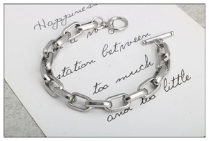 Detailed view of silver stainless steel chain bracelet with a classic T-bar toggle clasp