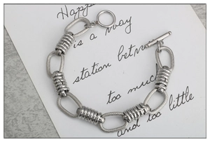 Detail of silver stainless steel toggle clasp and textured chain links for bracelet