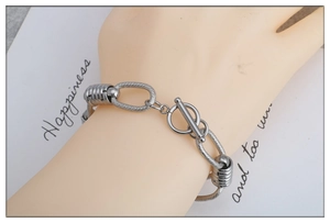 Detailed view of stainless steel OT buckle and spiral textured chain link on the bracelet
