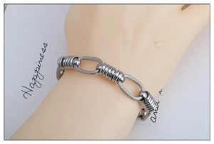 Close-up of stainless steel link chain bracelet with toggle clasp on wrist