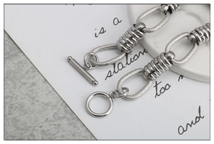 Detail view of silver stainless steel OT toggle clasp and textured chain link bracelet