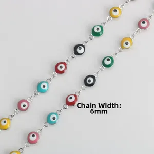 Detailed macro view of colorful 6mm evil eye enamel beads on a stainless steel chain