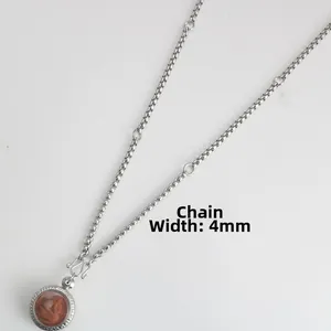 Detail view of 4mm stainless steel box chain necklace with religious Thai amulet pendant