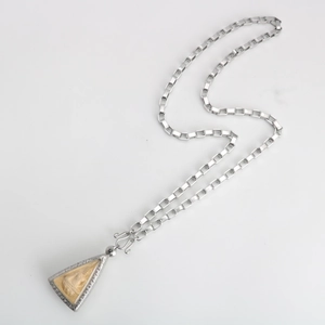Detail view of silver stainless steel box chain with an ornate Buddhist amulet pendant