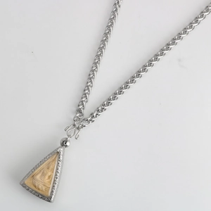 Detailed view of Thai Buddha amulet pendant with thick braided stainless steel chain