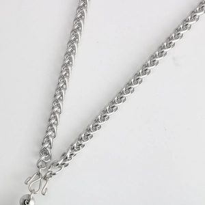 Detailed macro view of silver stainless steel wheat chain with a secure double hook clasp