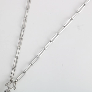 Macro shot of silver stainless steel paperclip chain necklace with lobster clasp detail