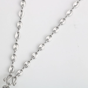 Detail of silver pig nose link chain in stainless steel with double S-shaped clasp closure